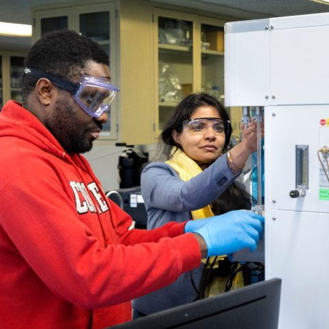 Engineering Ph.D. candidate Prince Ochonma works with Assistant Professor and Croll Sesquicentennial Fellow in the School of Civil and Environmental Engineering Greeshma Gadikota in a lab in Hollister Hall on Tuesday, January 10, 2023. (Ryan Young / Cornell University)